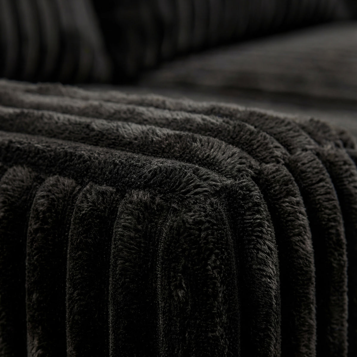 Detail view of Minky Black chaise lounger, showing fabric texture