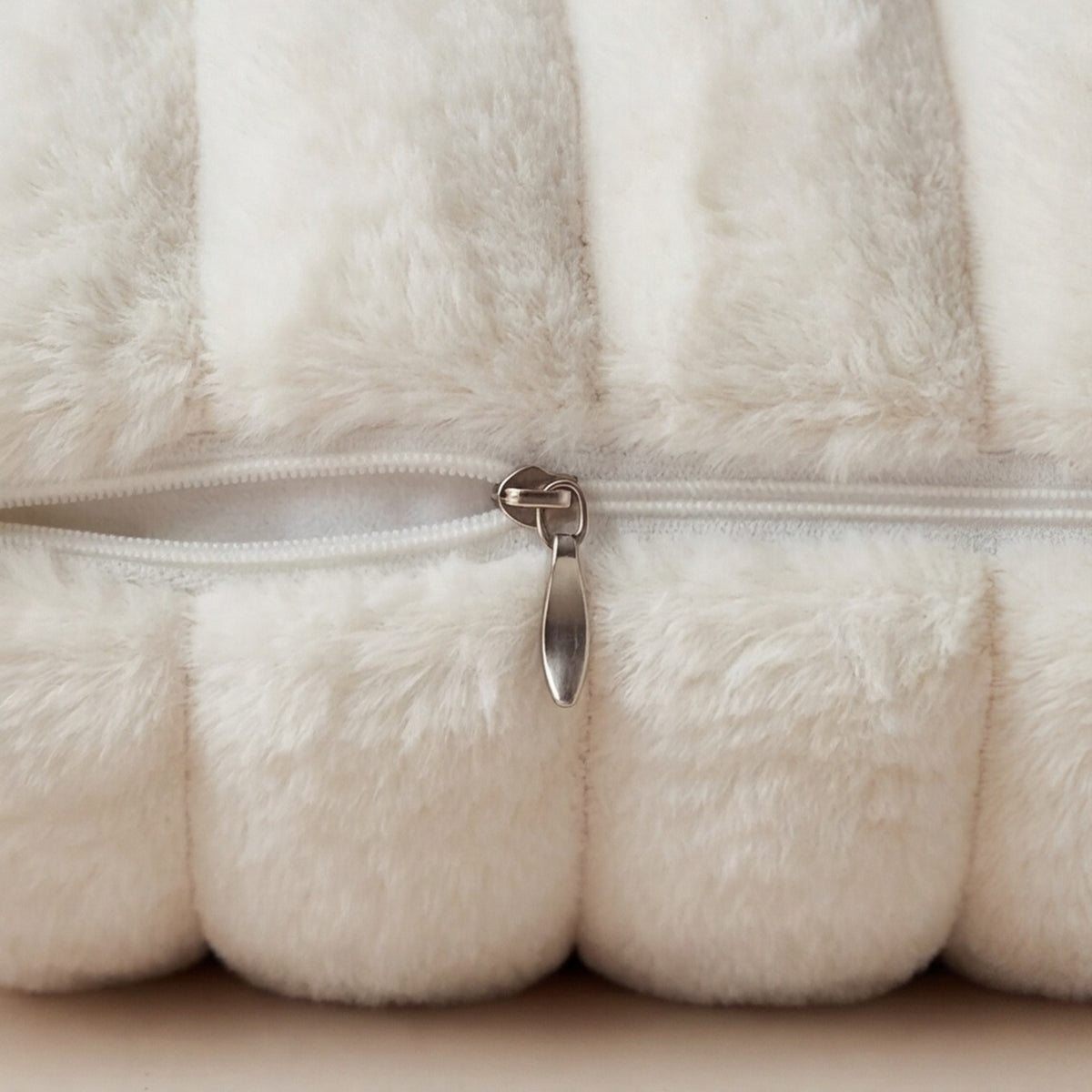 Close-up of removable cushion cover zipper on Minky Cream chaise lounger