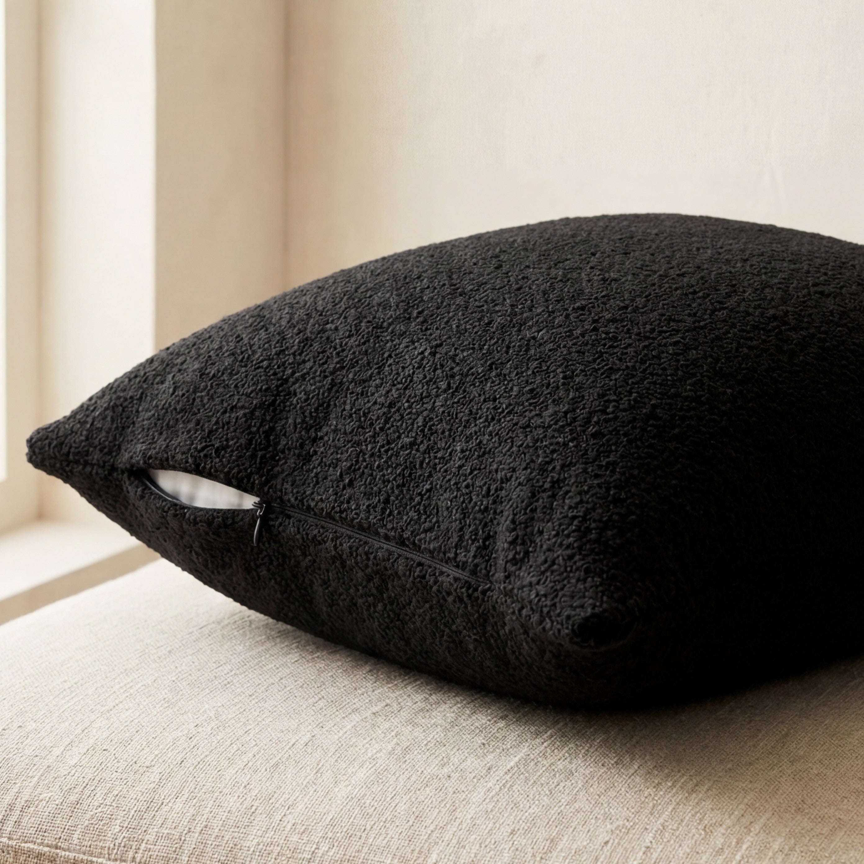 Cuddle Black chaise lounger styled with matching throw pillow