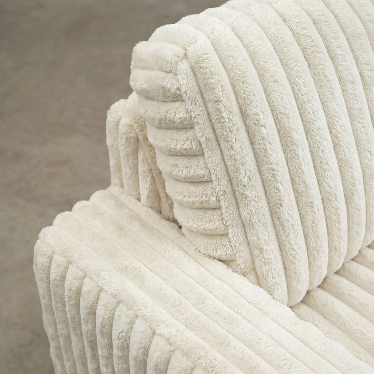 Detail view of Minky White chaise lounger, showing fabric texture