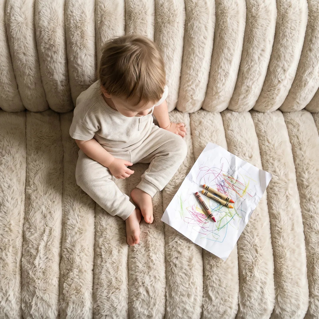 Toddler sitting on a plush couch